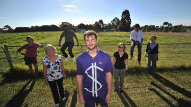 Mark Kowalczyk (centre) and former Wesley students and parents are protesting the school's plans to develop part of its land.