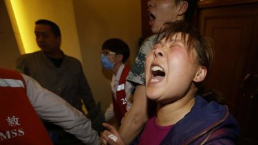 A distraught family member of a passenger aboard Malaysia Airlines MH370 shouts at journalists after watching the Malaysian PM's press conference.