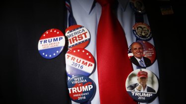 A delegate wears campaign buttons in support of Donald Trump, presumptive 2016 Republican presidential nominee, before the start of the Republican National Convention (RNC) in Cleveland, Ohio.