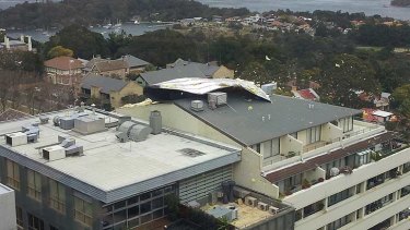 The roof begins to lift off the building in North Sydney.