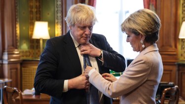 British Foreign Secretary Boris Johnson has his tie straightened by his Australian counterpart Foreign Minister Julie Bishop.