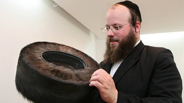 Hats my boy ... Australian-born shtreimel maker Moshe Weiner holds a hand-made fur hat at his Jerusalem workshop.