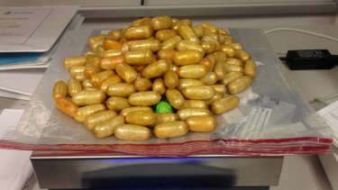 A smuggler was arrested with these drug-filled pellets in her stomach.