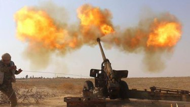 In this photo released on June 23, 2015, by a website of Islamic State militants, an Islamic State militant fires artillery against Syrian government forces in Hama city, Syria. Special troops called "Inghemasiyoun," Arabic for "those who immerse themselves," are possibly the deadliest weapon in the extremist group's arsenal: Fanatical and disciplined, they infiltrate their targets, unleash mayhem and fight to the death. (Militant website via AP)