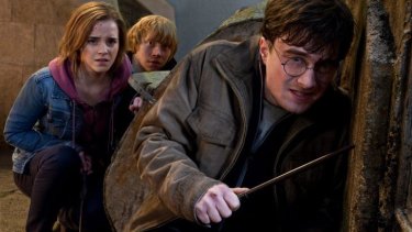 Danielle Radcliffe (right) as the boy wizard, with Emma Watson and Rupert Grint, in <i>Harry Potter and the Deathly Hallows: Part 2</i>.