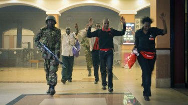 Civilians leave the mall on Saturday.