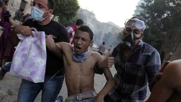 More to come ... protesters in Cairo carry a man injured in the clashes near Tahrir Square.
