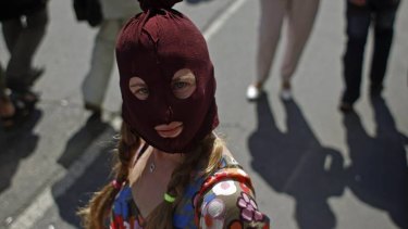 A supporter of female punk band Pussy Riot waits outside court.