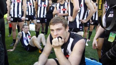 Exhausted: Heath Shaw (front), a seated Dane Swan and their Magpie teammates ponder another week of blood, sweat and toil.