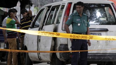 Bangladeshi police at the site where Italian citizen Cesare Tavella was gunned down by unidentified assailants in Dhaka last year. 