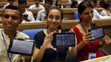 Students show off the first Aakash tablet.