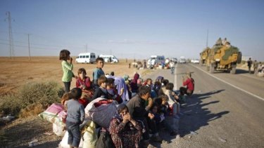 Syrian Kurdish refugees after crossing into Turkey.