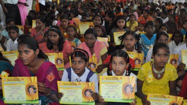 Indian girls hold up their name change certificates during a ceremony in Satara, 250 kilometres from Mumbai.