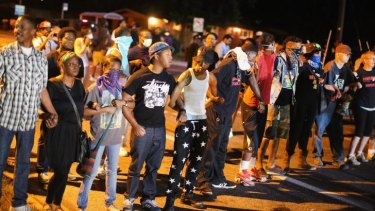 Demonstrators protest the shooting death of teenager Michael Brown in Ferguson.