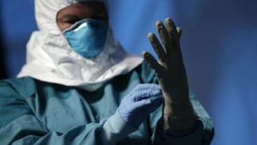 Gearing up: A nurse demonstrates protective equipment during an Ebola educational session for healthcare workers in New York.