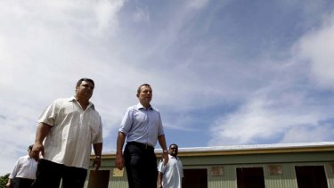 The full tour ... Federal Opposition leader, Tony Abbott takes a tour of the State House camp site, Menen. This site is currently a school but would be turned into a processing facility.