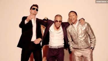 Robin Thicke, rapper T.I. and Pharrell Williams performing <i>Blurred Lines</i>.