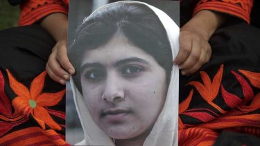 A student holds an image of Malala Yousufzai, who was shot by the Taliban during a rally.