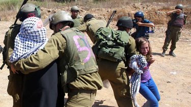 A Palestinian girl cries as Israeli soldiers arrest her mother during a protest over land confiscation in al-Nabi Saleh.