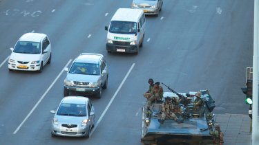 A military tank is seen with armed soldiers outside President Robert Mugabe's office in Harare.