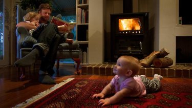 David Glen and his children at home in front of the fire.