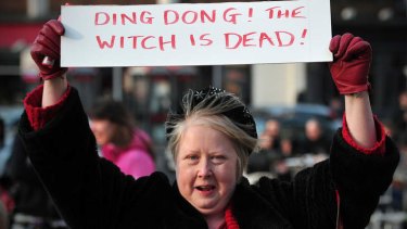 A woman celebrates the death of the former British PM.