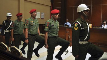 Brazen crime: Soldiers from Indonesia's elite special force enter the courtroom to attend their trial at the local military court in Yogyakarta.