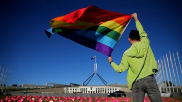 Marriage equality advocate Russell Nankervis with the rainbow flag during a 'Sea of Hearts' event in support of marriage equality at Parliament House earlier this month.