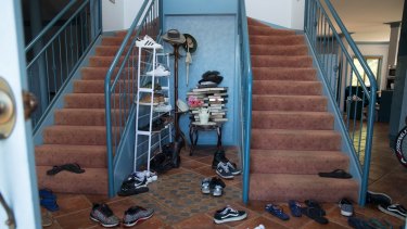 Shoes in the foyer of one of many properties rented by Frank Lin and turned into boarding houses for Taiwanese nationals who are working at the nearby Thomas Foods plant. 