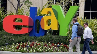 FILE - In this April 22, 2011 file photo, two pedestrians pass eBay headquarters in San Jose, Calif. EBay Inc. reports quarterly financial results Wednesday, Jan. 18, 2012, after the market close. (AP Photo/Paul Sakuma, File)