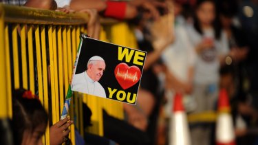 Well-wishers line the streets to catch a glimpse of Pope Francis in Manila.