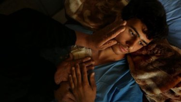 Volunteer fighter Ismail Abdul Hassan, 17, recovers in Baghdad's al-Wasiti hospital after being wounded by an improvised explosive device while patrolling Baghdad's hinterland.