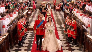 Britain's Prince William, left, and his wife, Kate, the Dutchess of Cambridge, walk down the aisle together at Westminster Abbey for the Royal Wedding in London