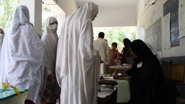Rizwana, second from the front, looking at camera, lines up to vote in Pakistan's general election on Saturday. More women were registered to vote than in any previous poll in the country. But women were still disenfranchised. In conservative areas, clerics banned women from voting or threatened punishment for their families if they did. In Peshawar militants tried to kill women voters.