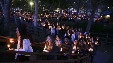 People gather at a park in Isla Vista for a candlelight vigil to honour the victims of the mass shooting.