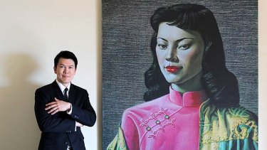 Wayne Young with a print of Tretchikoff's painting of his mother titled 'Miss Wong'.