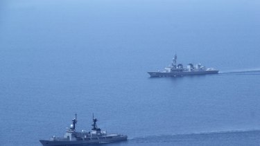 A Japanese Navy ship (right) along with a Philippine Navy vessel take part in a joint exercise less than 300 kilometres from a Philippine-claimed shoal, under Chinese control, in the South China Sea. 