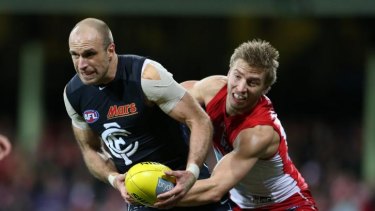 Chris Judd tries to escape the clutches of Sydney's Kieren Jack in round 17.