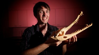 Monash University student Chris Walmsley with a 3D print-out of a crocodile head.