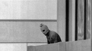 Dark day ... an unidentified member of a terrorist group appears on the balcony of the building where members of the Israeli Olympic team were being held hostage during Munich Olympics in September 1972.