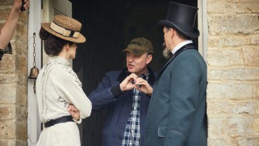 Keira Knightley with director Wash Westmoreland and Dominic West on the set of Colette. 