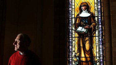 Bishop Pat Power near a window of Mary MacKillop at St Christopher's, Canberra, in October 2010.