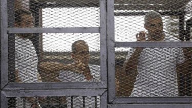 Al-Jazeera journalists Baher Mohamed, Peter Greste and Mohammed Fahmy in court in Cairo.