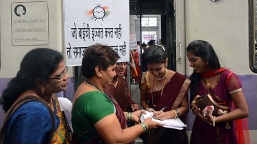 Making their voices heard ... women in New Delhi sign a petition condemning the recent gang rape.