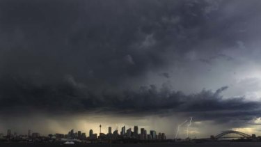'Twas a dark and stormy afternoon ... the view from Bradleys Head yesterday captured the severe thunderstorms tracking south of Sydney.