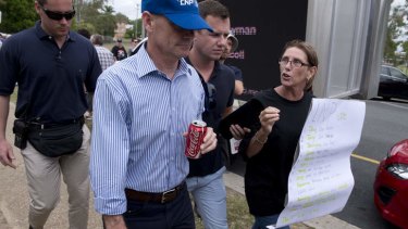 Premier Campbell Newman is yelled at by a protester after leaving the Humpybong state school in Redcliffe where he was supporting local LNP candidate Kerri-anne Dooley.