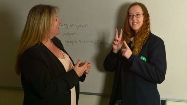 Amanda Purcell and Heidi Beasley-Ellich communicate using Auslan.