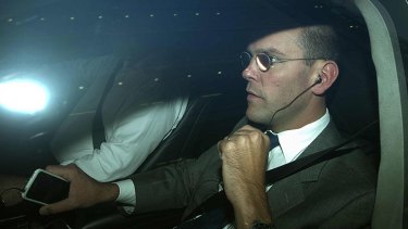 James Murdoch is driven away from the offices of News International in London overnight.