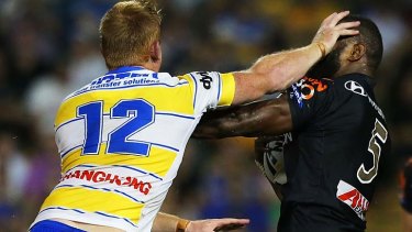 Tussle: Matthew Ryan and Marika Koroibete clash in Friday night's game at Leichhardt Oval. The Tigers beat the Eels 31-18.