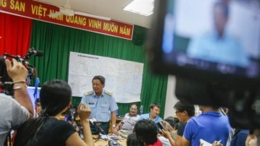 Deputy commander of Vietnam Air Force Do Minh Tuan (third from left) speaks during a news conference after a mission to find missing Malaysia Airlines flight.